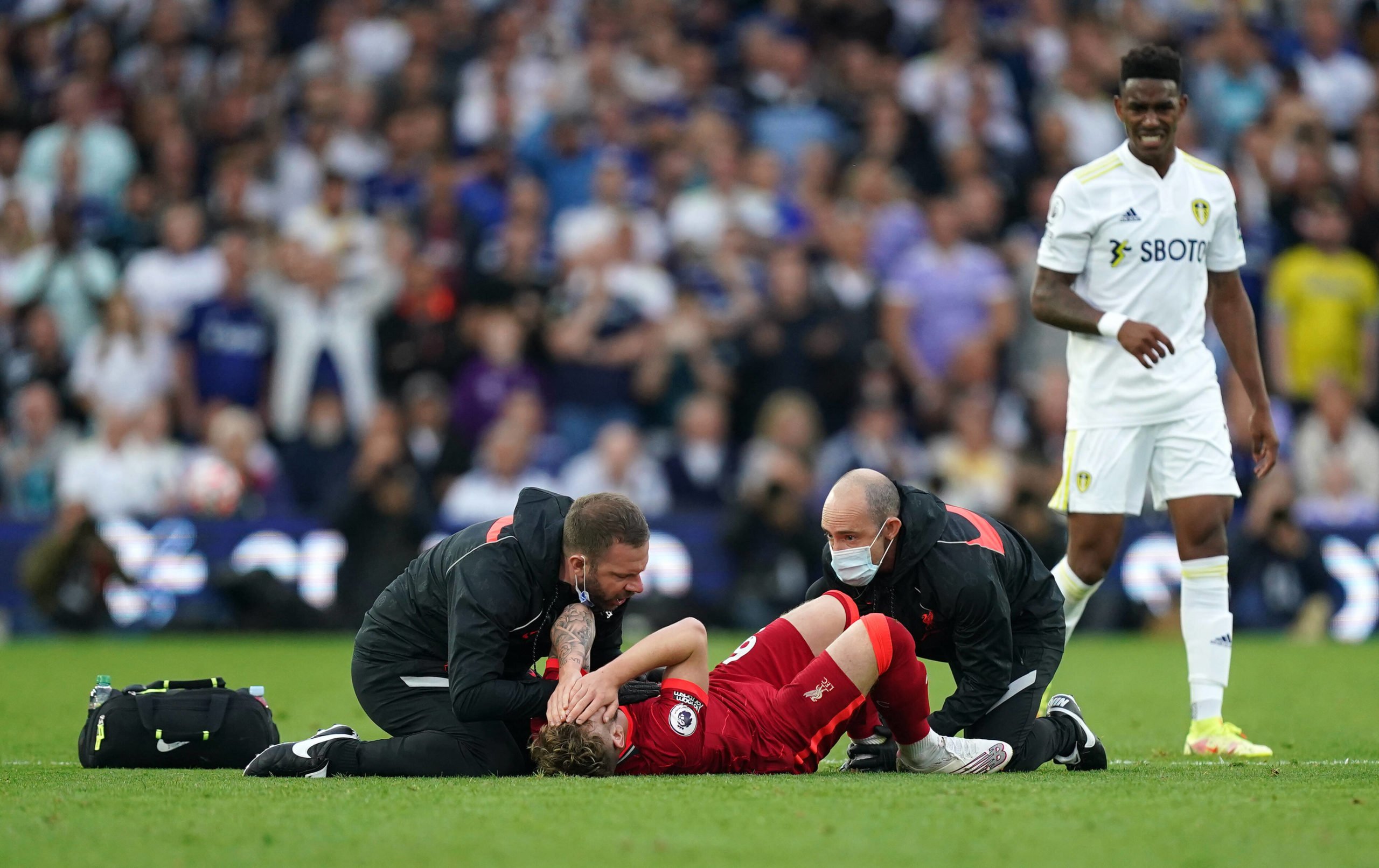 Liverpool teenager Harvey Elliott receiving treatment after suffering a horrible injury