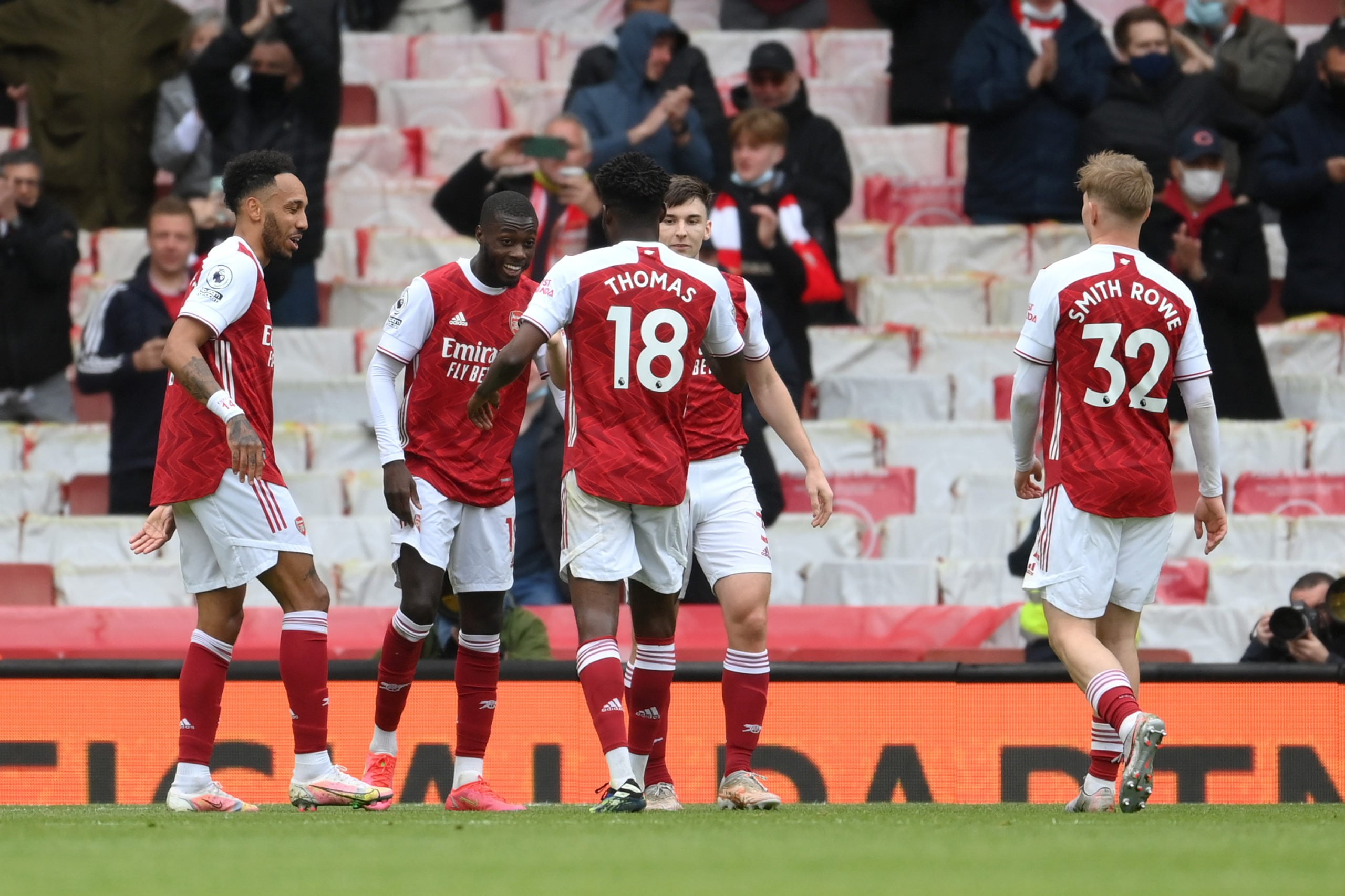 LONDON, ENGLAND - MAY 23: Nicolas Pepe of Arsenal celebrates after scoring their team's second goal with Thomas Partey, Kieran Tierney, Pierre-Emerick Aubameyang and Emile Smith Rowe  during the Premier League match between Arsenal and Brighton & Hove Albion at Emirates Stadium on May 23, 2021 in London, England. A limited number of fans will be allowed into Premier League stadiums as Coronavirus restrictions begin to ease in the UK. (Photo by Mike Hewitt/Getty Images)