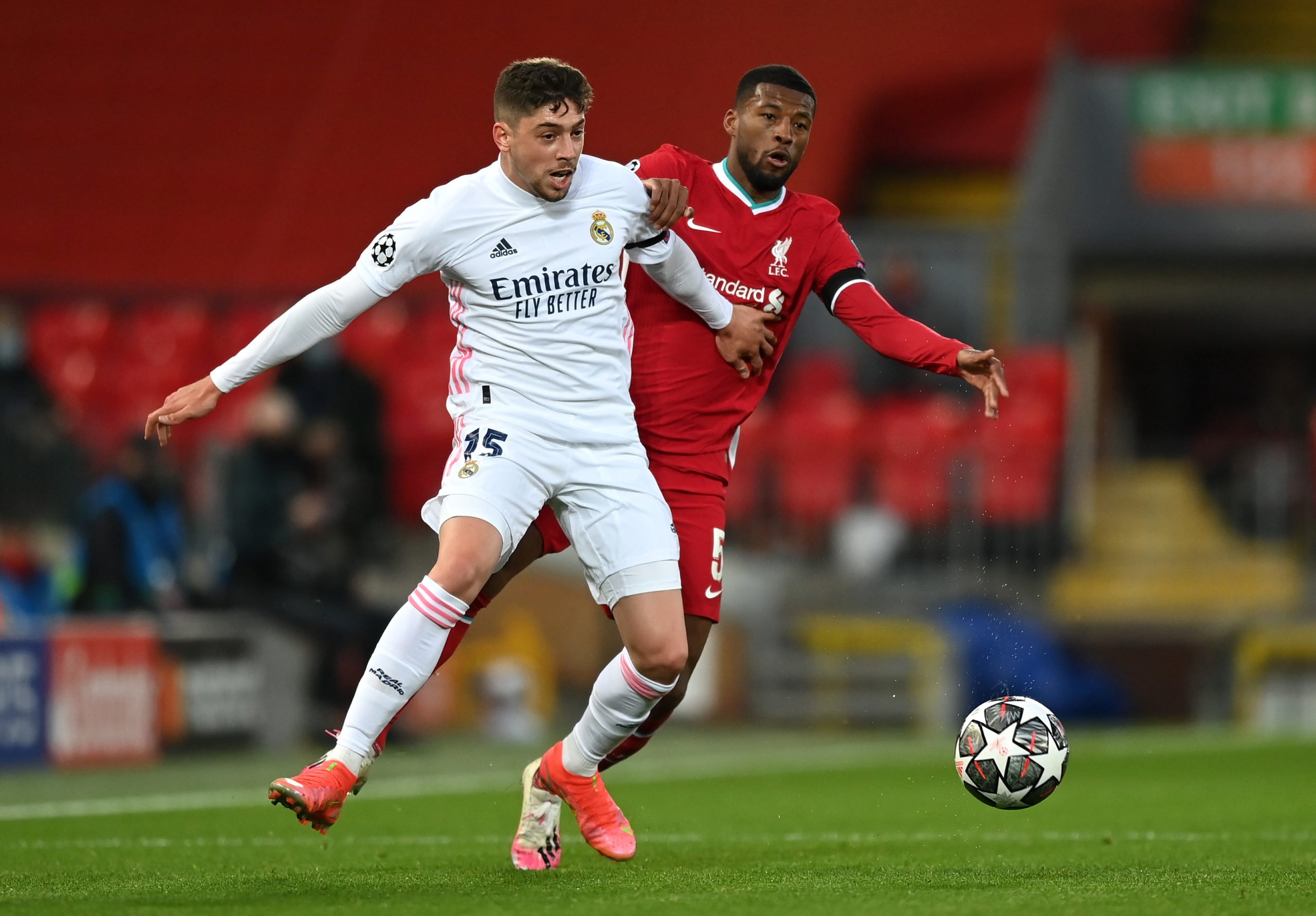 LIVERPOOL, ENGLAND - APRIL 14: Federico Valverde of Real Madrid battles for possession with Georginio Wijnaldum of Liverpool during the UEFA Champions League Quarter Final Second Leg match between Liverpool FC and Real Madrid at Anfield on April 14, 2021 in Liverpool, England. Sporting stadiums around the UK remain under strict restrictions due to the Coronavirus Pandemic as Government social distancing laws prohibit fans inside venues resulting in games being played behind closed doors. (Photo by Shaun Botterill/Getty Images)The 4th Official uses images provided by the following image agency: Getty Images (https://www.gettyimages.de/) Imago Images (https://www.imago-images.de/)