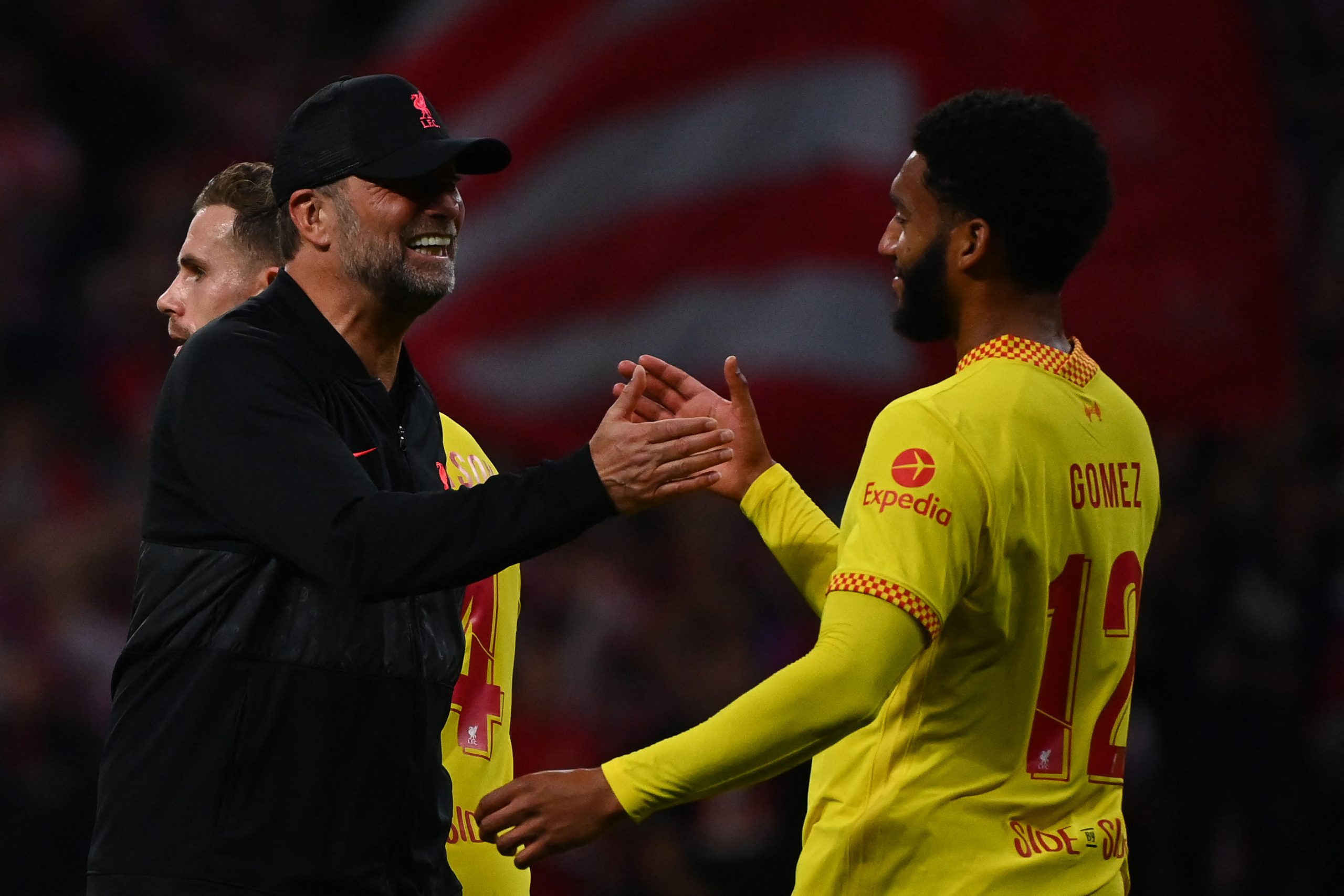 Liverpool's German coach Jurgen Klopp (L) celebrates with Liverpool's English defender Joe Gomez at the end of the UEFA Champions League Group B football match between Atletico Madrid and Liverpool at the Wanda Metropolitano stadium in Madrid on October 19, 2021. (Photo by GABRIEL BOUYS / AFP) (Photo by GABRIEL BOUYS/AFP via Getty Images)The 4th Official uses images provided by the following image agency: Getty Images (https://www.gettyimages.de/) Imago Images (https://www.imago-images.de/)