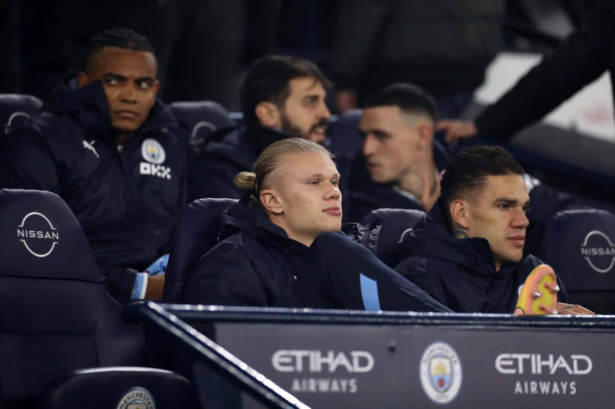 Manchester City star Erling Haaland sitting on the bench
