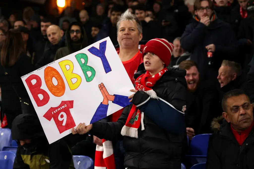 A young Liverpool fan with a Roberto Firmino poster.