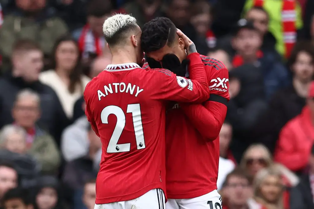 Manchester United's Brazilian midfielder Casemiro is being consoled after red card