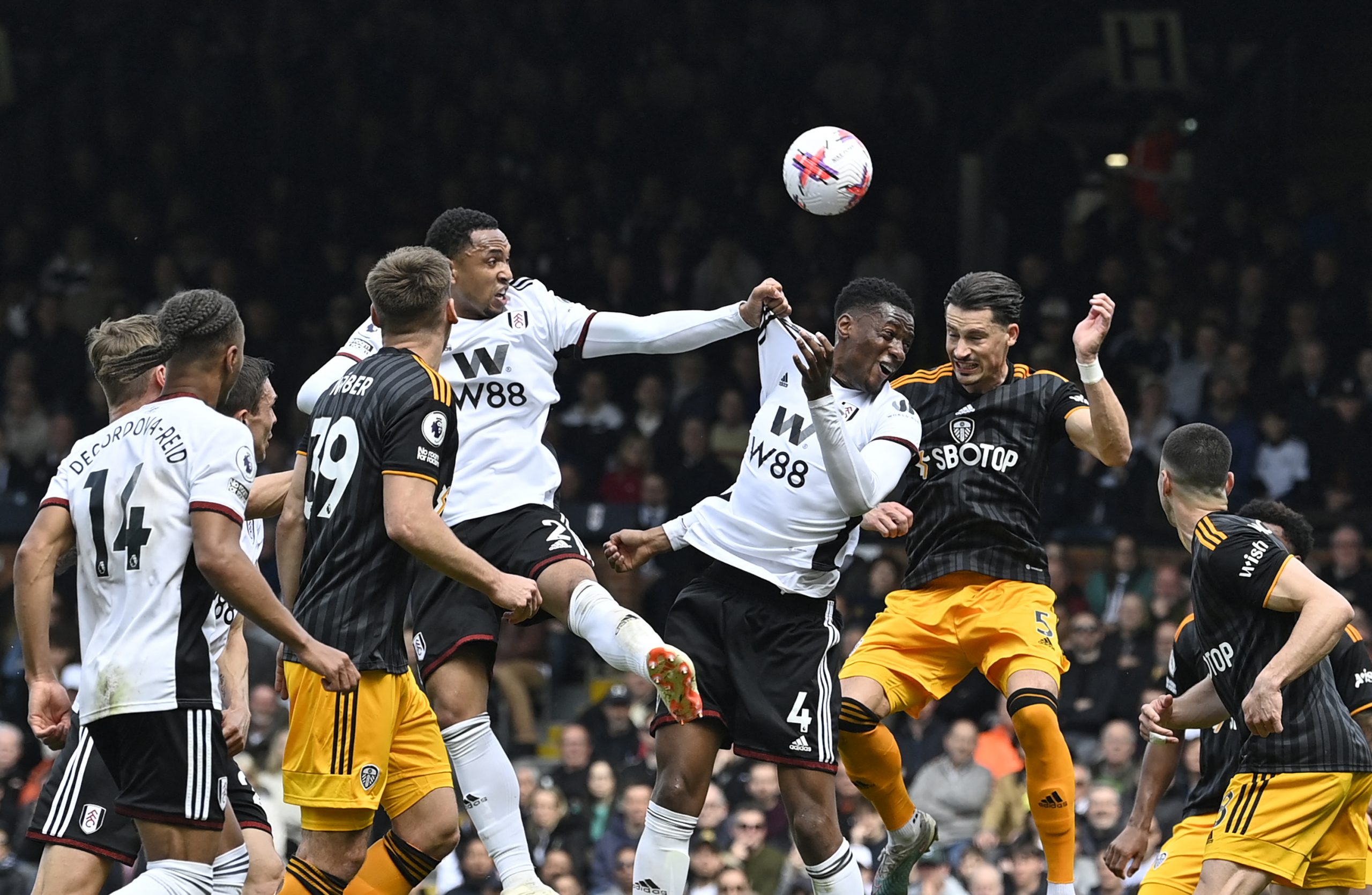 Fulham's Dutch defender Kenny Tete (centre left), Fulham's English defender Tosin Adarabioyo (centre right) and Leeds United's German defender Robin Koch (2R) compete for the ball during the English Premier League football match between Fulham and Leeds United at Craven Cottage in London on April 22, 2023. (Photo by JUSTIN TALLIS / AFP) / RESTRICTED TO EDITORIAL USE. No use with unauthorized audio, video, data, fixture lists, club/league logos or 'live' services. Online in-match use limited to 120 images. An additional 40 images may be used in extra time. No video emulation. Social media in-match use limited to 120 images. An additional 40 images may be used in extra time. No use in betting publications, games or single club/league/player publications. /  (Photo by JUSTIN TALLIS/AFP via Getty Images)