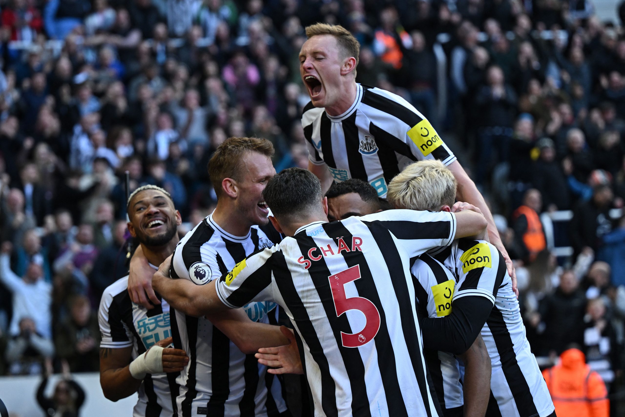 Newcastle United's English striker Callum Wilson (C) celebrates with teammates after scoring their second goal during the English Premier League football match between Newcastle United and Manchester United at St James' Park in Newcastle-upon-Tyne, north east England on April 2, 2023. (Photo by Oli SCARFF / AFP) / RESTRICTED TO EDITORIAL USE. No use with unauthorized audio, video, data, fixture lists, club/league logos or 'live' services. Online in-match use limited to 120 images. An additional 40 images may be used in extra time. No video emulation. Social media in-match use limited to 120 images. An additional 40 images may be used in extra time. No use in betting publications, games or single club/league/player publications. /  (Photo by OLI SCARFF/AFP via Getty Images)