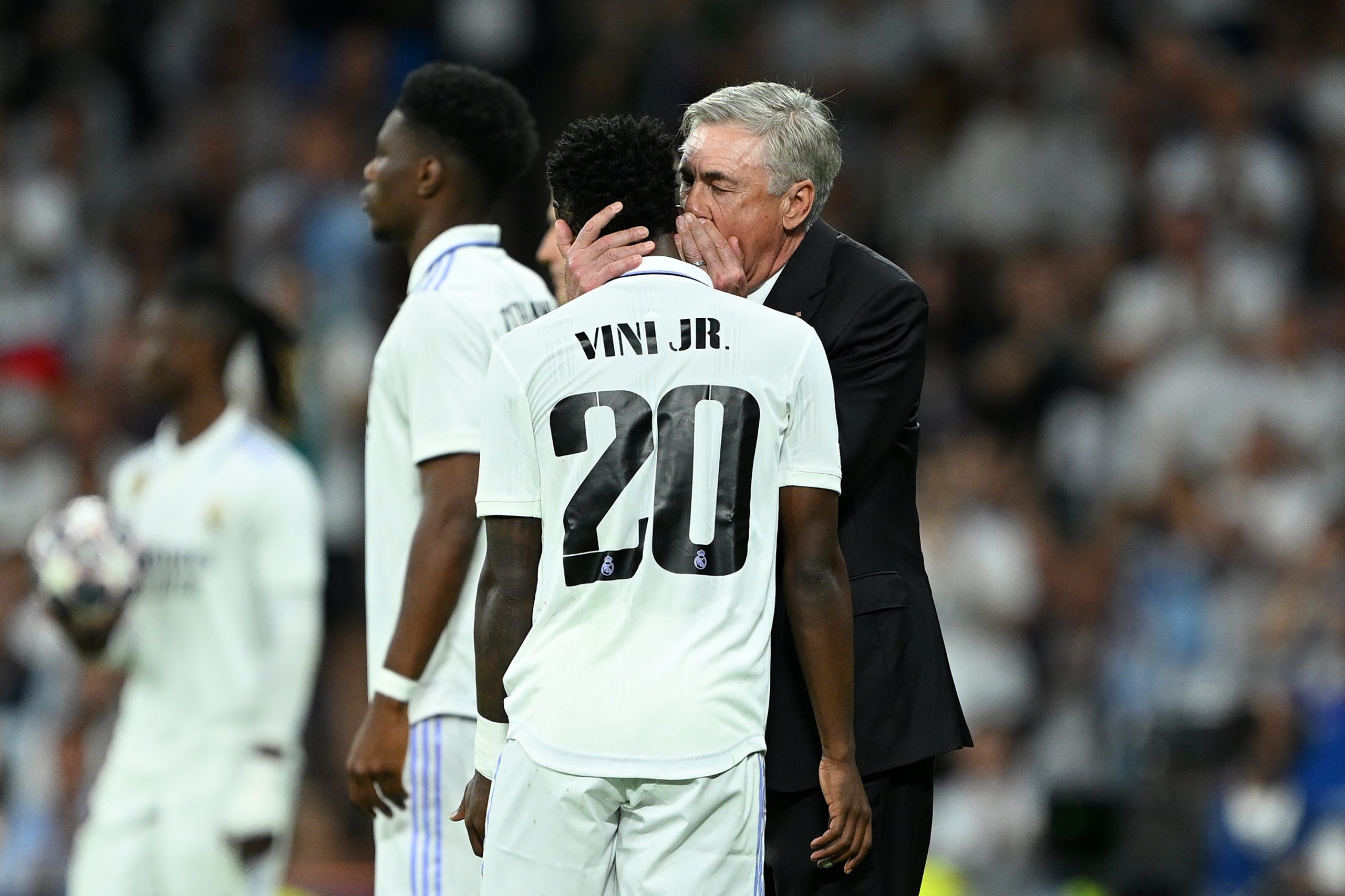 MADRID, SPAIN - MAY 09: Carlo Ancelotti embraces Vinicius Junior of Real Madrid during the UEFA Champions League semi-final first leg match between Real Madrid and Manchester City FC at Estadio Santiago Bernabeu on May 09, 2023 in Madrid, Spain. (Photo by David Ramos/Getty Images)