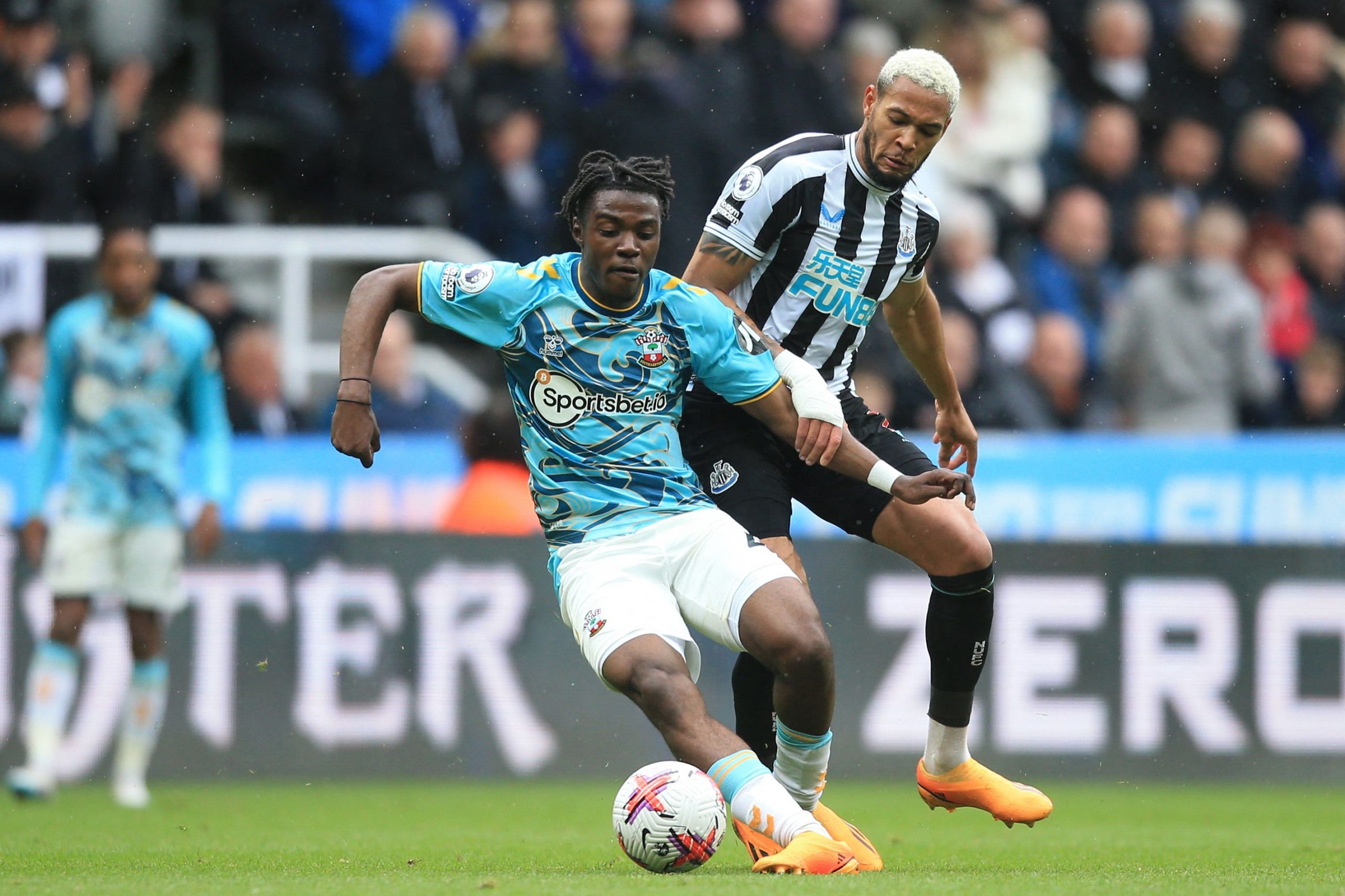 Southampton's Belgian midfielder Romeo Lavia (L) fights for the ball with Newcastle United's Brazilian striker Joelinton during the English Premier League football match between Newcastle United and Southampton at St James' Park in Newcastle-upon-Tyne, north east England on April 30, 2023. (Photo by Lindsey Parnaby / AFP) / RESTRICTED TO EDITORIAL USE. No use with unauthorized audio, video, data, fixture lists, club/league logos or 'live' services. Online in-match use limited to 120 images. An additional 40 images may be used in extra time. No video emulation. Social media in-match use limited to 120 images. An additional 40 images may be used in extra time. No use in betting publications, games or single club/league/player publications. /  (Photo by LINDSEY PARNABY/AFP via Getty Images)