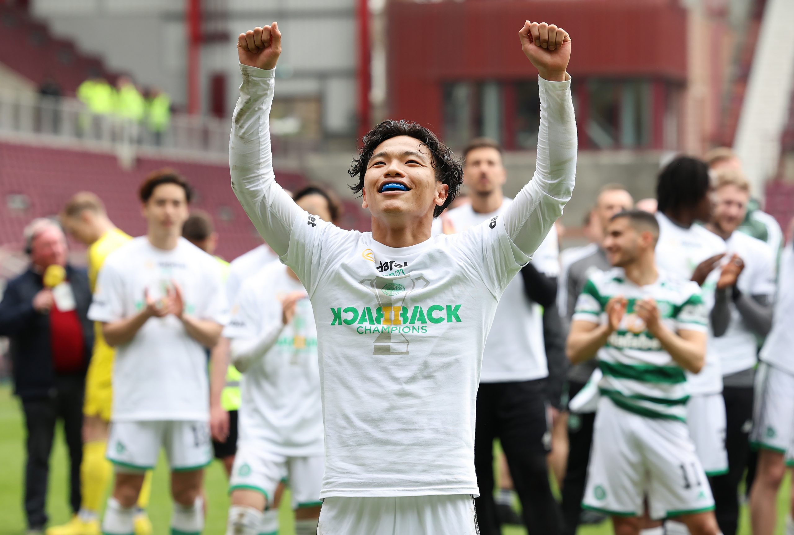 Celtic star Reo Hatate celebrates the league triumph 