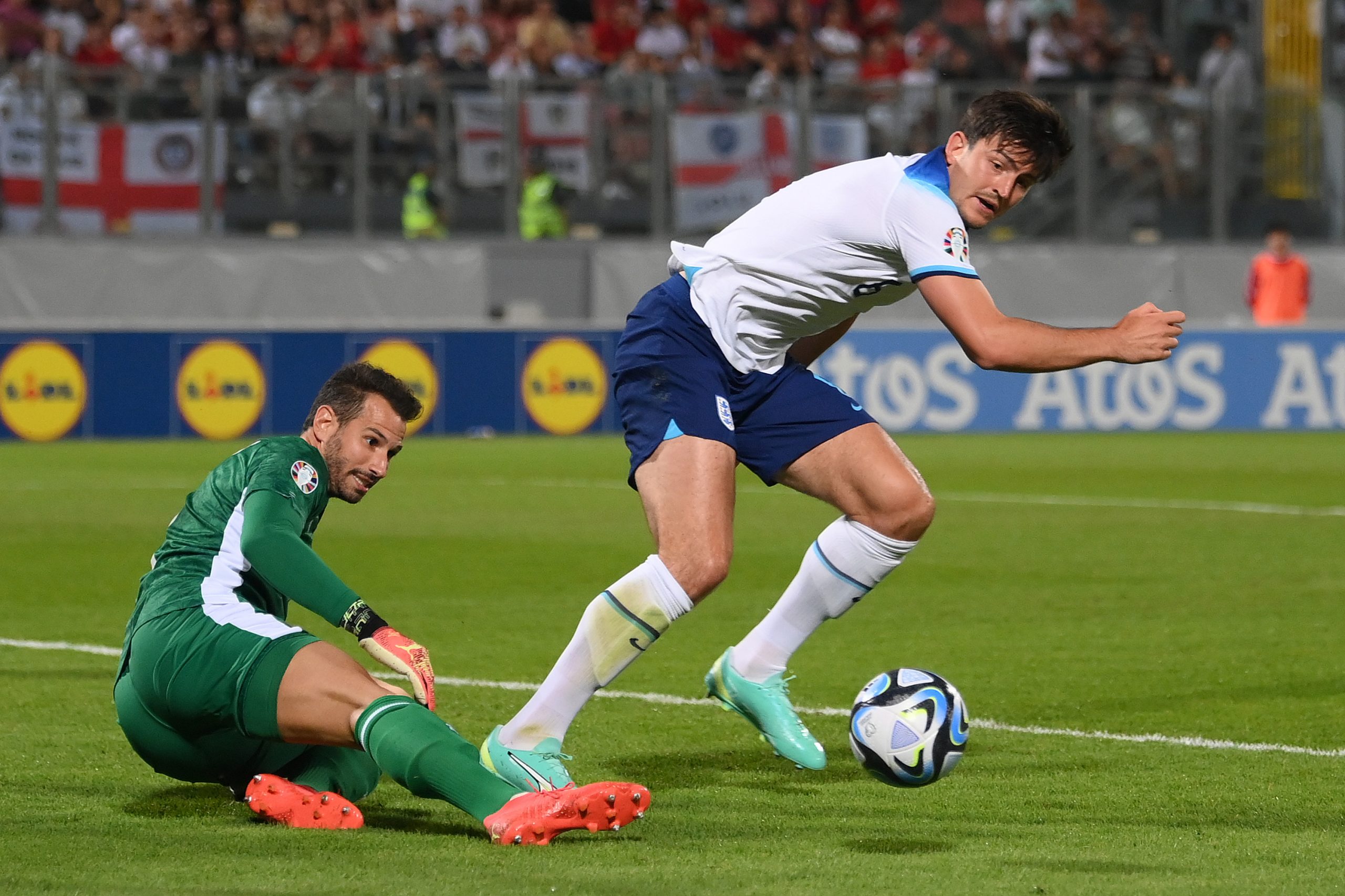 VALLETTA, MALTA - JUNE 16: Harry Maguire of England is challenged by Henry Bonello of Malta during the UEFA EURO 2024 qualifying round group C match between Malta and England at Ta' Qali Stadium on June 16, 2023 in Valletta, Malta. (Photo by Mike Hewitt/Getty Images)