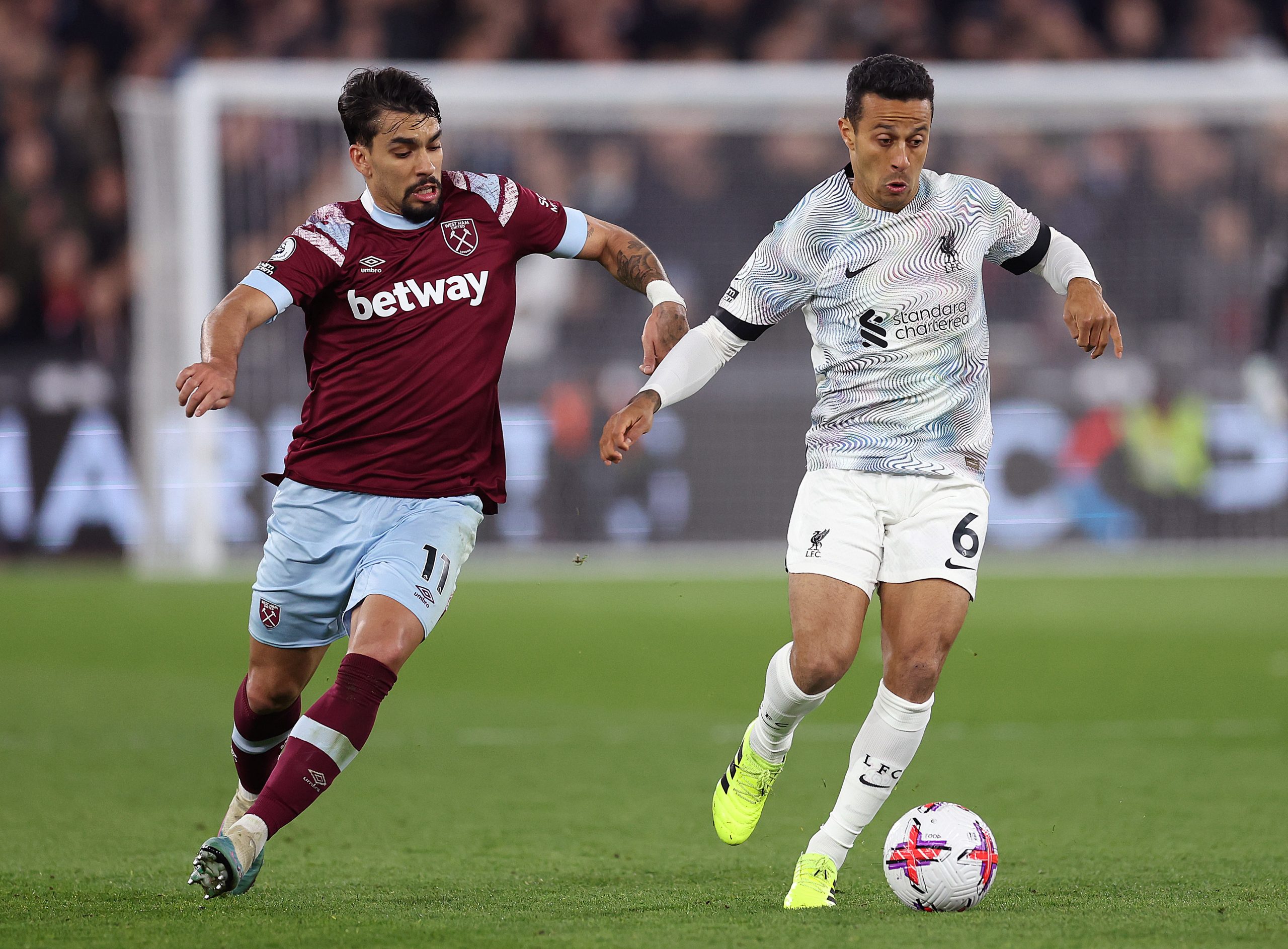 LONDON, ENGLAND - APRIL 26: Thiago Alcantara of Liverpool runs with the ball whilst under pressure from Lucas Paqueta of West Ham United during the Premier League match between West Ham United and Liverpool FC at London Stadium on April 26, 2023 in London, England. (Photo by Julian Finney/Getty Images)