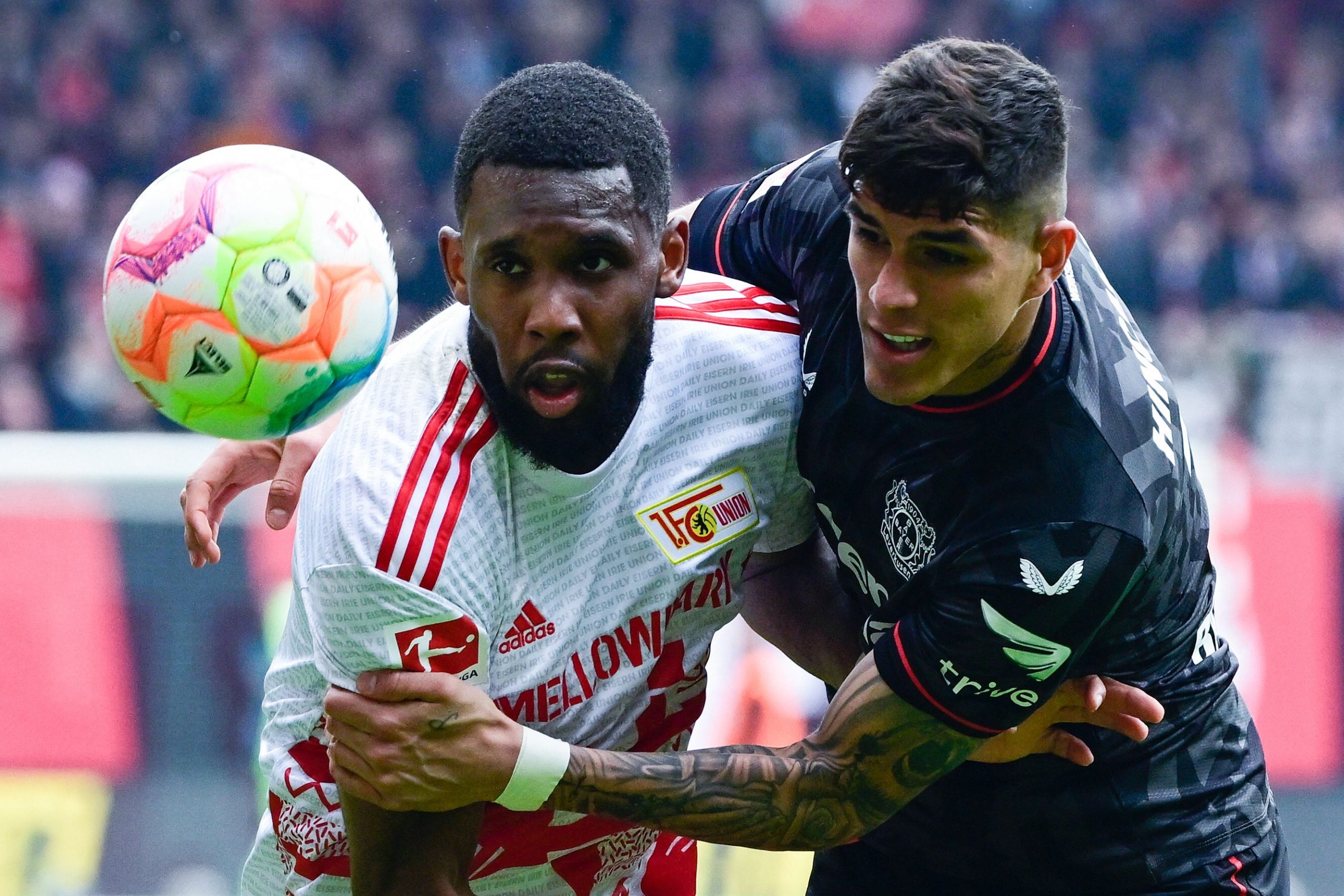 Leverkusen's Ecuadorian defender Piero Hincapie (R) and Union Berlin's French forward Jordan Siebatcheu vie for the ball during the German first division Bundesliga football match between Union Berlin and Bayer 04 Leverkusen in Berlin on April 29, 2023. (Photo by John MACDOUGALL / AFP) / DFL REGULATIONS PROHIBIT ANY USE OF PHOTOGRAPHS AS IMAGE SEQUENCES AND/OR QUASI-VIDEO (Photo by JOHN MACDOUGALL/AFP via Getty Images)