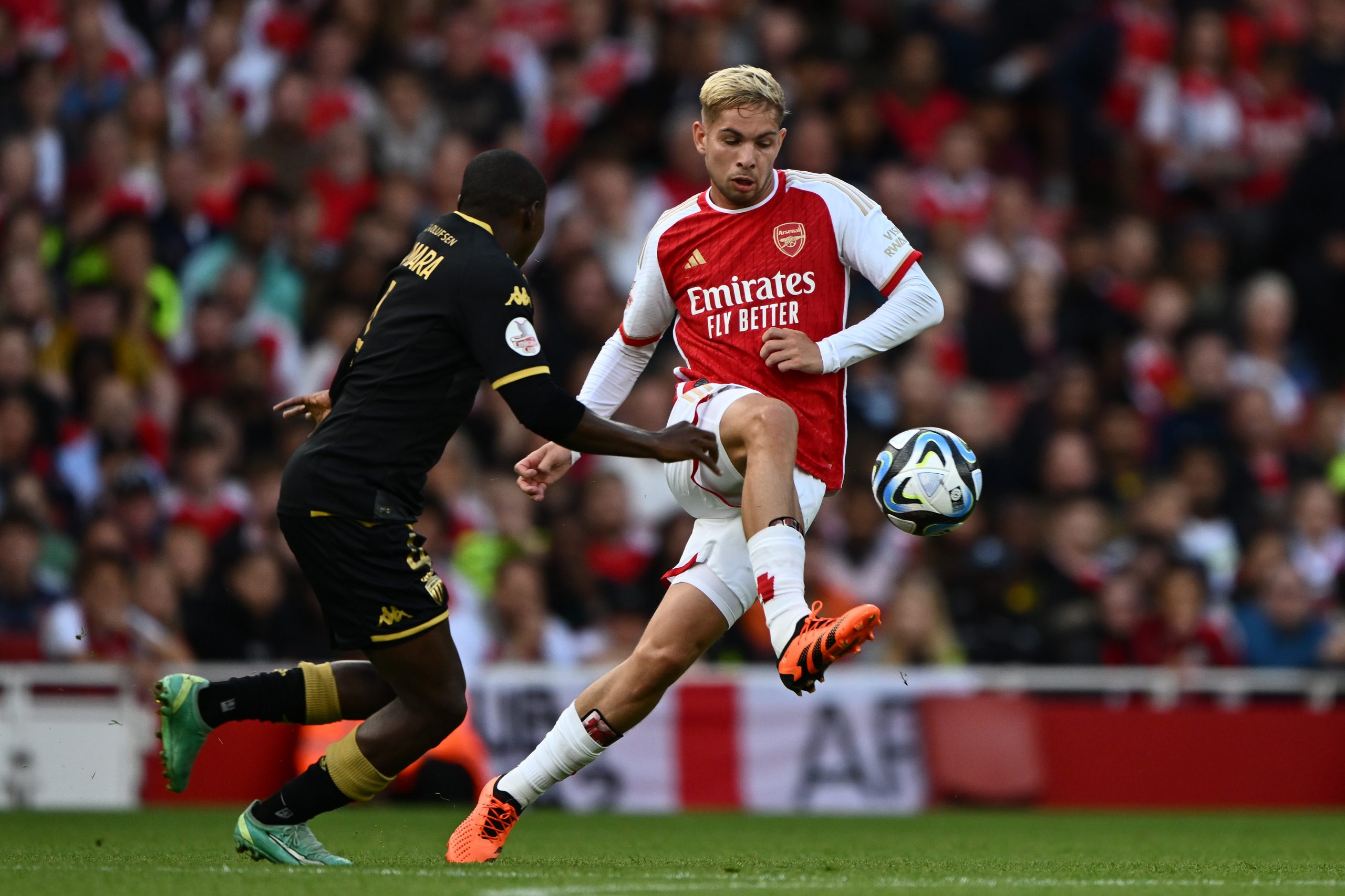 LONDON, ENGLAND - AUGUST 02: Emile Smith Rowe of Arsenal is challenged by Mohamed Camara of AS Monaco during the pre-season friendly match between Arsenal FC and AS Monaco at Emirates Stadium on August 02, 2023 in London, England. (Photo by Mike Hewitt/Getty Images)