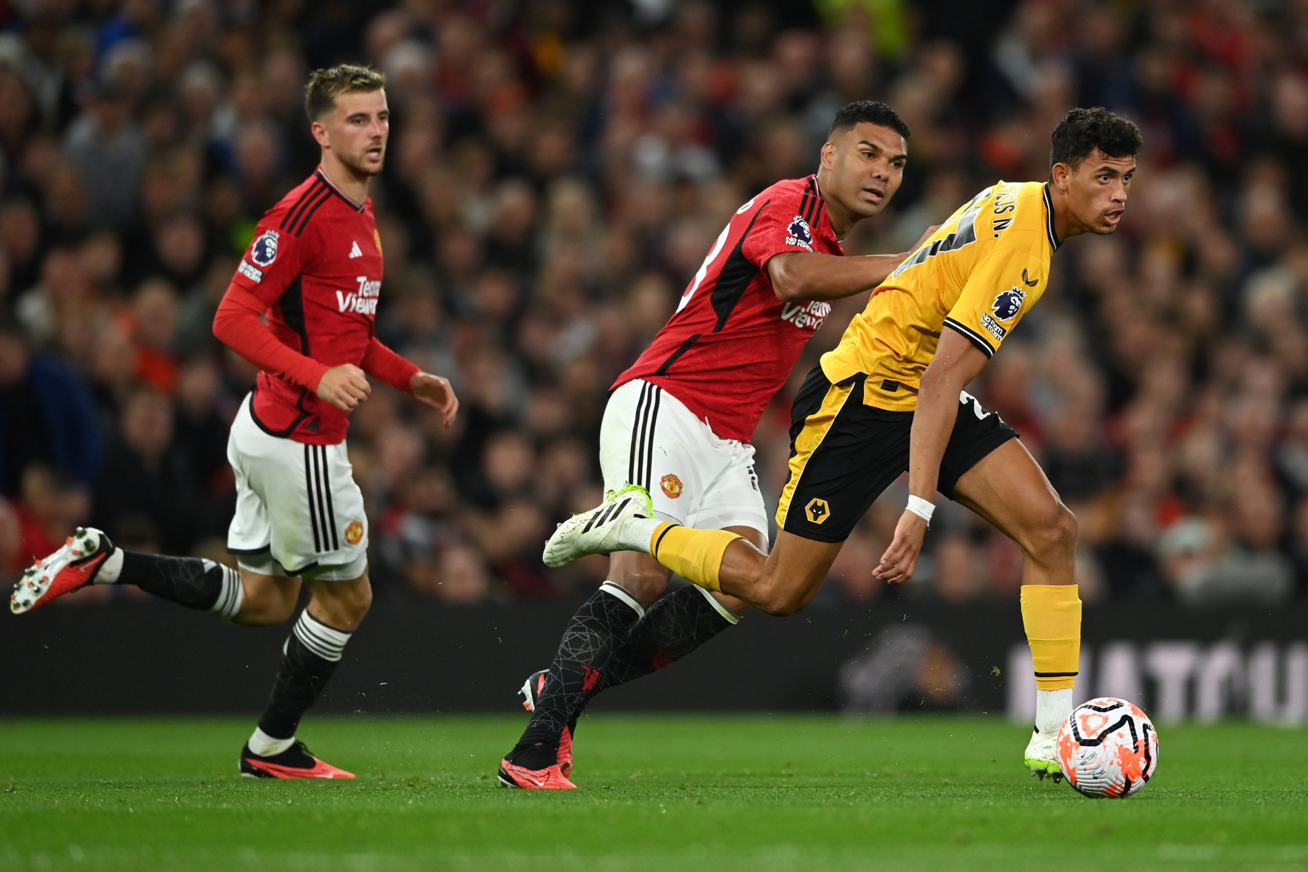 MANCHESTER, ENGLAND - AUGUST 14: Matheus Nunes of Wolverhampton Wanderers is challenged by Casemiro of Manchester United during the Premier League match between Manchester United and Wolverhampton Wanderers at Old Trafford on August 14, 2023 in Manchester, England. (Photo by Gareth Copley/Getty Images)