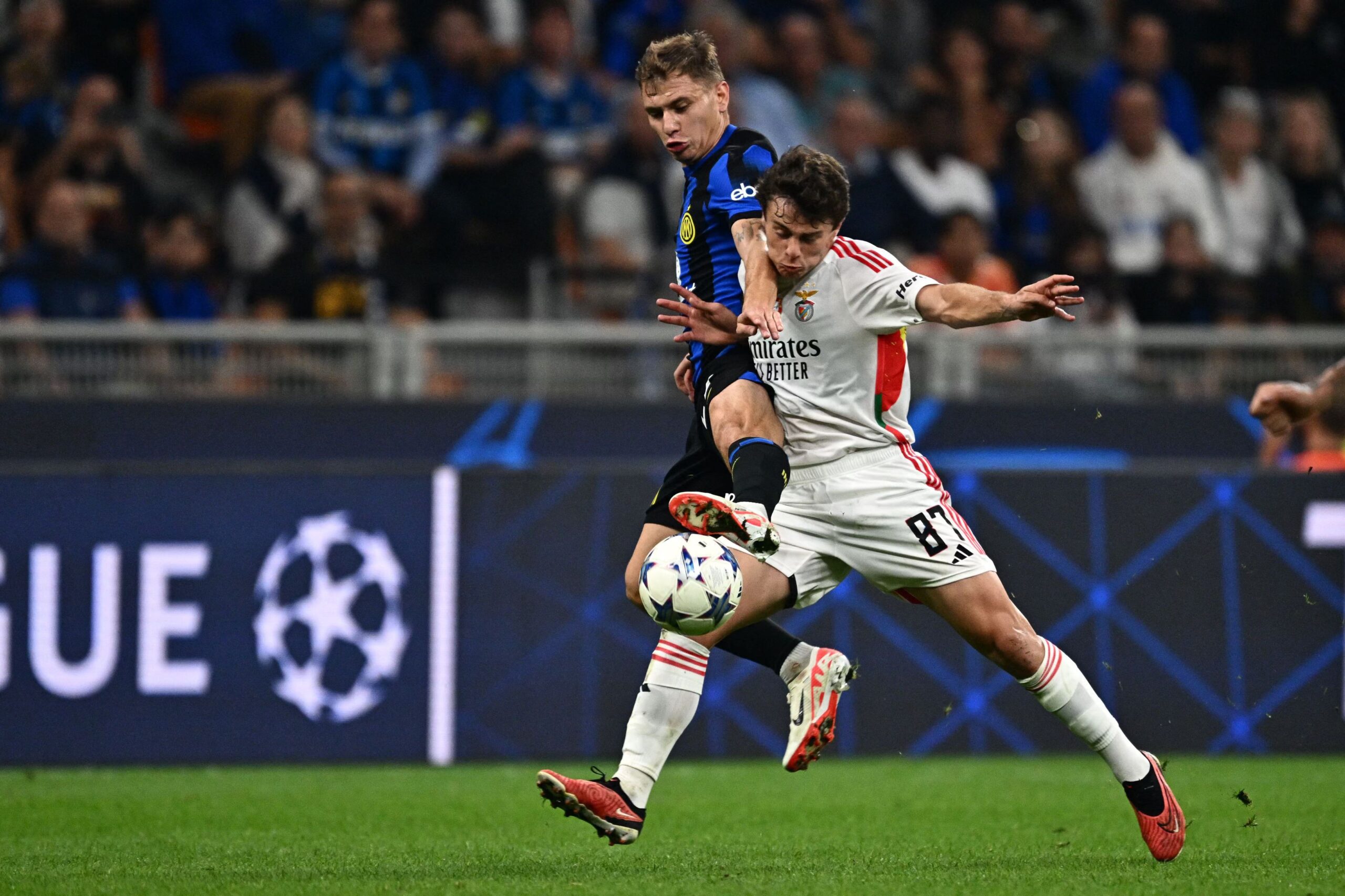 Inter Milan's Italian midfielder #23 Nicolo Barella (L) fights for the ball with Benfica's Portuguese midfielder #87 Joao Neves during the UEFA Champions League 1st round day 2 Group D football match Inter Milan vs Benfica at the San Siro stadium in Milan on October 3, 2023. (Photo by GABRIEL BOUYS / AFP) (Photo by GABRIEL BOUYS/AFP via Getty Images)