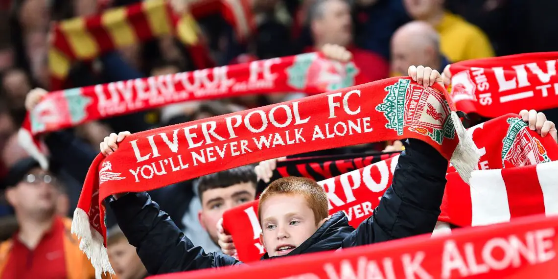 Supporters holding Liverpool's scarfs cheer for their team during the English League Cup third round football match between Liverpool and Leicester City at Anfield in Liverpool, north west England on September 27, 2023. (Photo by PETER POWELL / AFP) / RESTRICTED TO EDITORIAL USE. No use with unauthorized audio, video, data, fixture lists, club/league logos or 'live' services. Online in-match use limited to 120 images. An additional 40 images may be used in extra time. No video emulation. Social media in-match use limited to 120 images. An additional 40 images may be used in extra time. No use in betting publications, games or single club/league/player publications. /  (Photo by PETER POWELL/AFP via Getty Images)