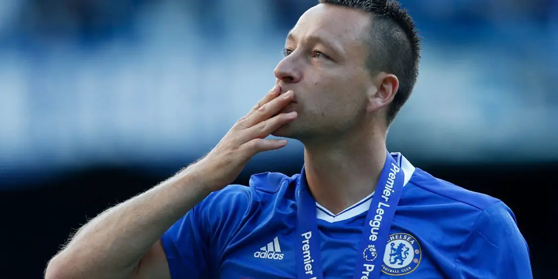 Chelsea's English defender John Terry salutes the crowd at the end of the presentation ceremony for the English Premier League trophy at the end of the Premier League football match between Chelsea and Sunderland at Stamford Bridge in London on May 21, 2017. - Chelsea's extended victory parade reached a climax with the trophy presentation on May 21, 2017 after being crowned Premier League champions with two games to go. (Photo by Ian KINGTON / AFP) / RESTRICTED TO EDITORIAL USE. No use with unauthorized audio, video, data, fixture lists, club/league logos or 'live' services. Online in-match use limited to 75 images, no video emulation. No use in betting, games or single club/league/player publications. /  (Photo by IAN KINGTON/AFP via Getty Images)