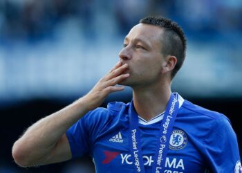 Chelsea's English defender John Terry salutes the crowd at the end of the presentation ceremony for the English Premier League trophy at the end of the Premier League football match between Chelsea and Sunderland at Stamford Bridge in London on May 21, 2017. - Chelsea's extended victory parade reached a climax with the trophy presentation on May 21, 2017 after being crowned Premier League champions with two games to go. (Photo by Ian KINGTON / AFP) / RESTRICTED TO EDITORIAL USE. No use with unauthorized audio, video, data, fixture lists, club/league logos or 'live' services. Online in-match use limited to 75 images, no video emulation. No use in betting, games or single club/league/player publications. /  (Photo by IAN KINGTON/AFP via Getty Images)