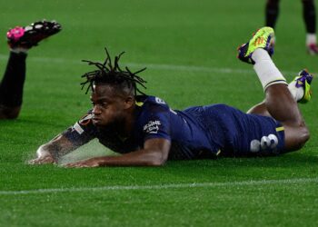 Fenerbahce's Belgian forward Michy Batshuayi falls down during the UEFA Europa League last 16 first leg football match between Sevilla FC and Fenerbahce SK at the Ramon Sanchez-Pizjuan stadium in Seville on March 9, 2023. (Photo by CRISTINA QUICLER / AFP) (Photo by CRISTINA QUICLER/AFP via Getty Images)