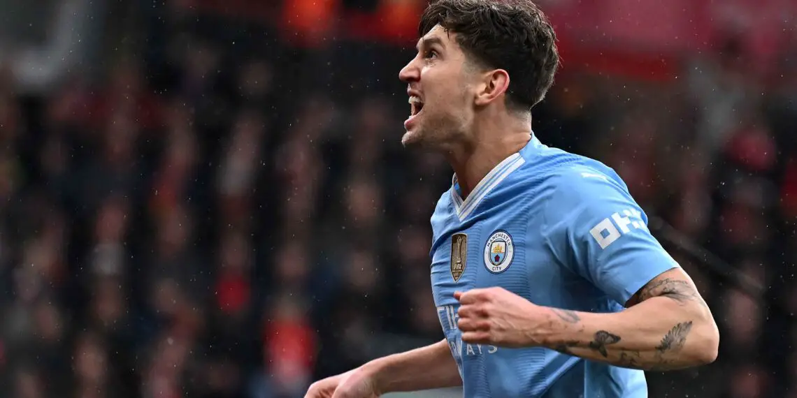 Manchester City's English defender #05 John Stones celebrates scoring the opening goal during the English Premier League football match between Liverpool and Manchester City at Anfield in Liverpool, north west England on March 10, 2024. (Photo by Paul ELLIS / AFP)