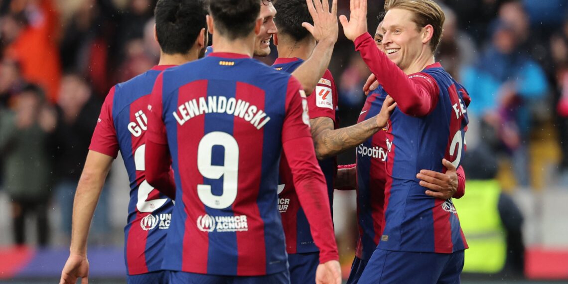 Barcelona's Dutch midfielder #21 Frenkie de Jong (R) celebrates with teammates scoring his team's third goal with teammates during the Spanish league football match between FC Barcelona and Getafe CF at the Estadi Olimpic Lluis Companys in Barcelona on February 24, 2024. (Photo by LLUIS GENE / AFP) (Photo by LLUIS GENE/AFP via Getty Images)