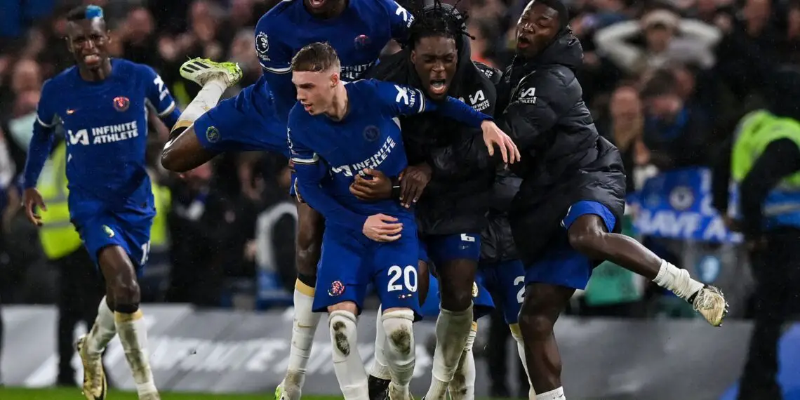 Chelsea's English midfielder #20 Cole Palmer (C) celebrates with teammates after scoring the fourth and winning goal of his team during the English Premier League football match between Chelsea and Manchester United at Stamford Bridge in London on April 4, 2024. (Photo by Glyn KIRK / AFP) / RESTRICTED TO EDITORIAL USE
