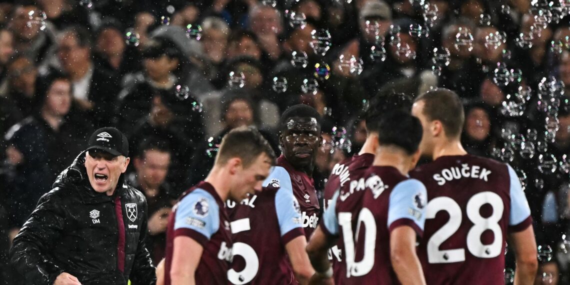 West Ham United's French defender #04 Kurt Zouma (C) celebrates after scoring his team first goal during the English Premier League football match between West Ham United and Tottenham Hotspur at the London Stadium, in London on April 2, 2024. (Photo by Ben Stansall / AFP)