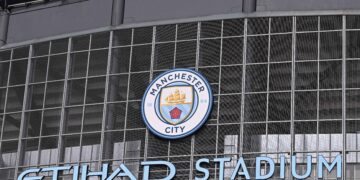 The club's badge is pictured on the outside of English Premier League football club Manchester City's Etihad stadium in Manchester, north-west England on April 20, 2021. - British Prime Minister Boris Johnson will host a meeting of football chiefs and fans' representatives today as they consider what action to take over the proposed European Super League. (Photo by Paul ELLIS / AFP) (Photo by PAUL ELLIS/AFP via Getty Images)
