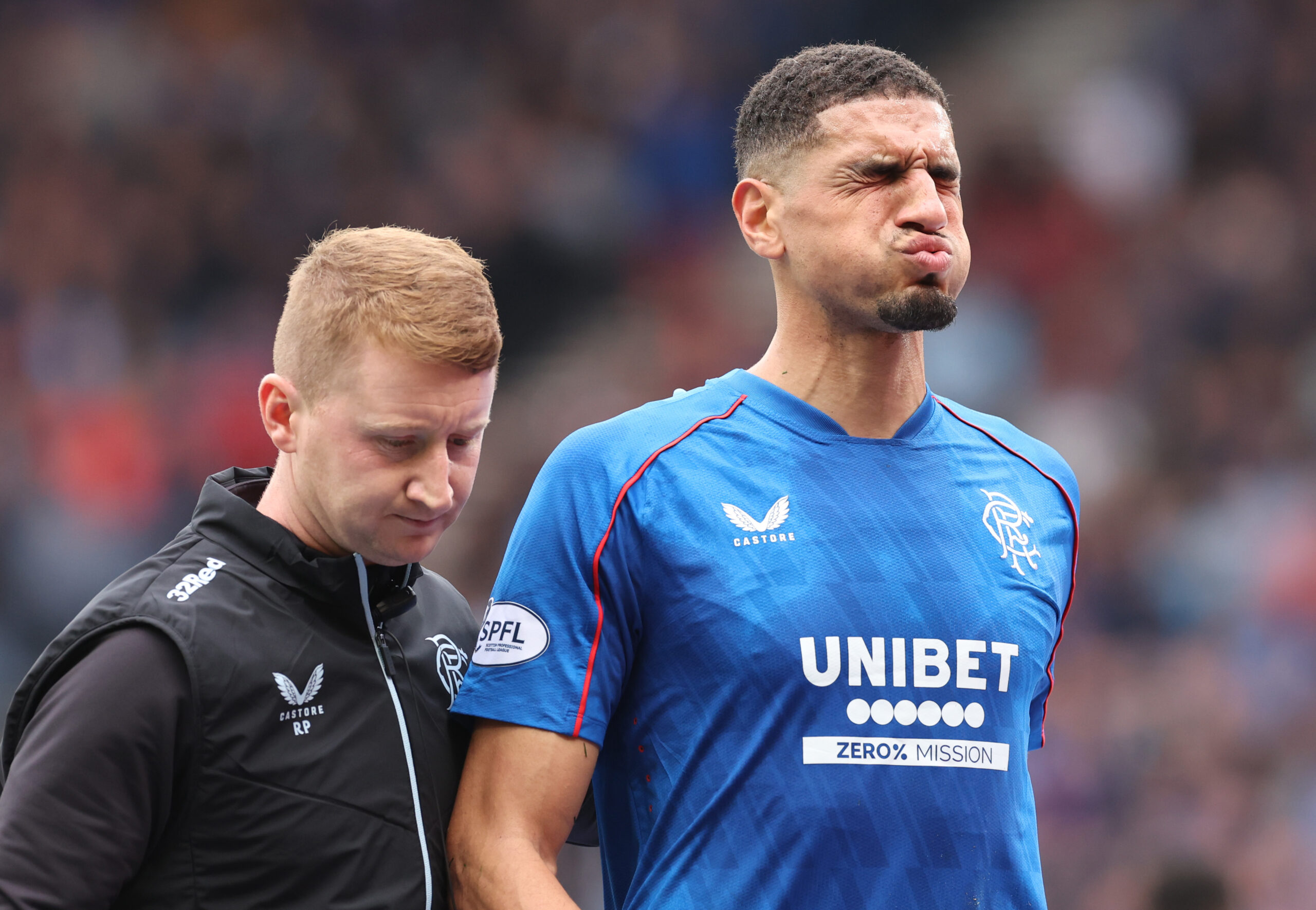 Rangers defender Leon Balogun leaves the pitch with an injury