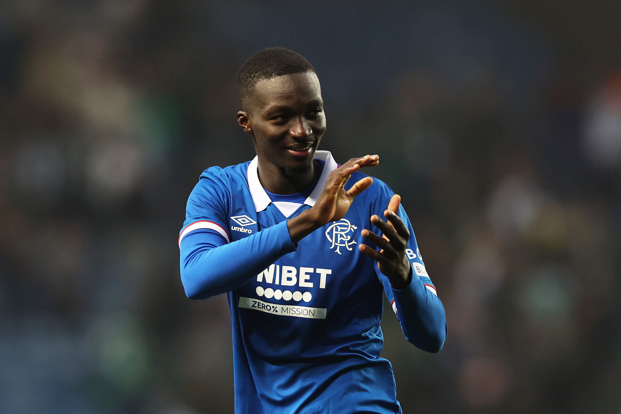 Rangers midfielder Mohamed Diomande applauds the fans