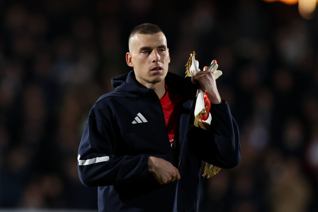 Real Madrid goalkeeper Andriy Lunin standing on the pitch during a match.