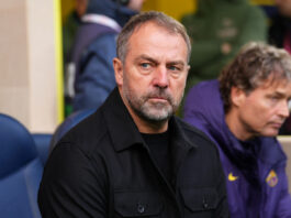 Barcelona Move To Secure Strategic Future At Camp Nou: Why Is The Board Rushing This Project? FC Barcelona manager Hansi Flick during a match at Camp Nou, symbolizing the club's push for a contract extension until 2028 and his tactical revitalisation of the squad.