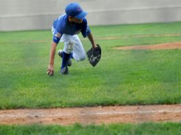 Why Sports Apparel Matters More Than We Think for Young Players a young boy in Chicago Cubs jersey playing baseball