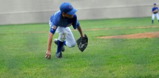 Why Sports Apparel Matters More Than We Think for Young Players a young boy in Chicago Cubs jersey playing baseball