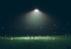 people playing football at night