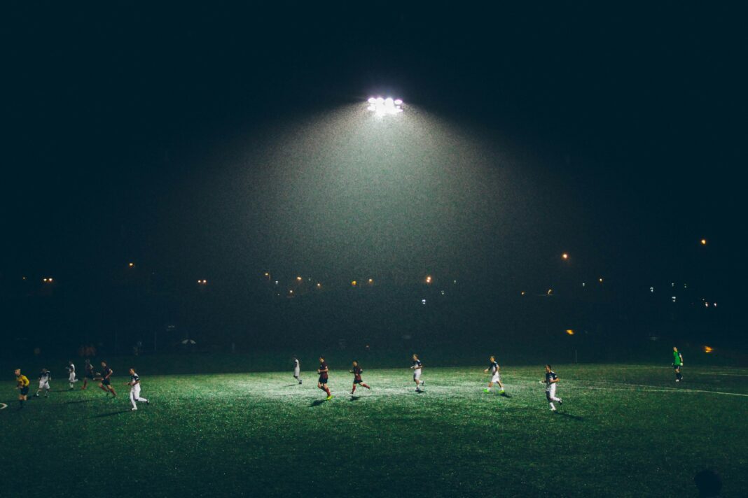 people playing football at night