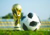 How Do You Keep Millions of Diverse World Cup Fans Connected Between Matches? The World Cup trophy on the ground with a football