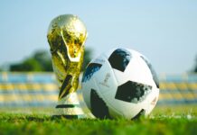 How Do You Keep Millions of Diverse World Cup Fans Connected Between Matches? The World Cup trophy on the ground with a football