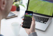 The Rise Of Second-Screen Entertainment During Live Football Events Man tracking the score on phone