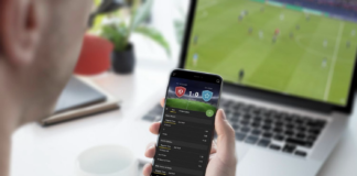 The Rise Of Second-Screen Entertainment During Live Football Events Man tracking the score on phone